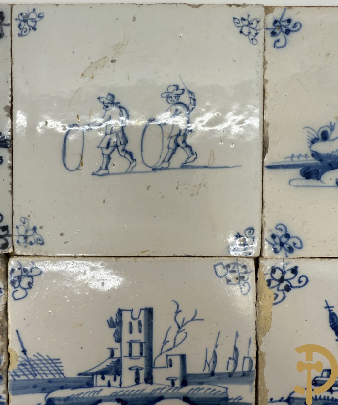 Negen Delftse tegeltjes met geanimeerd decor (6 stuks) en landschappen (3 stuks)