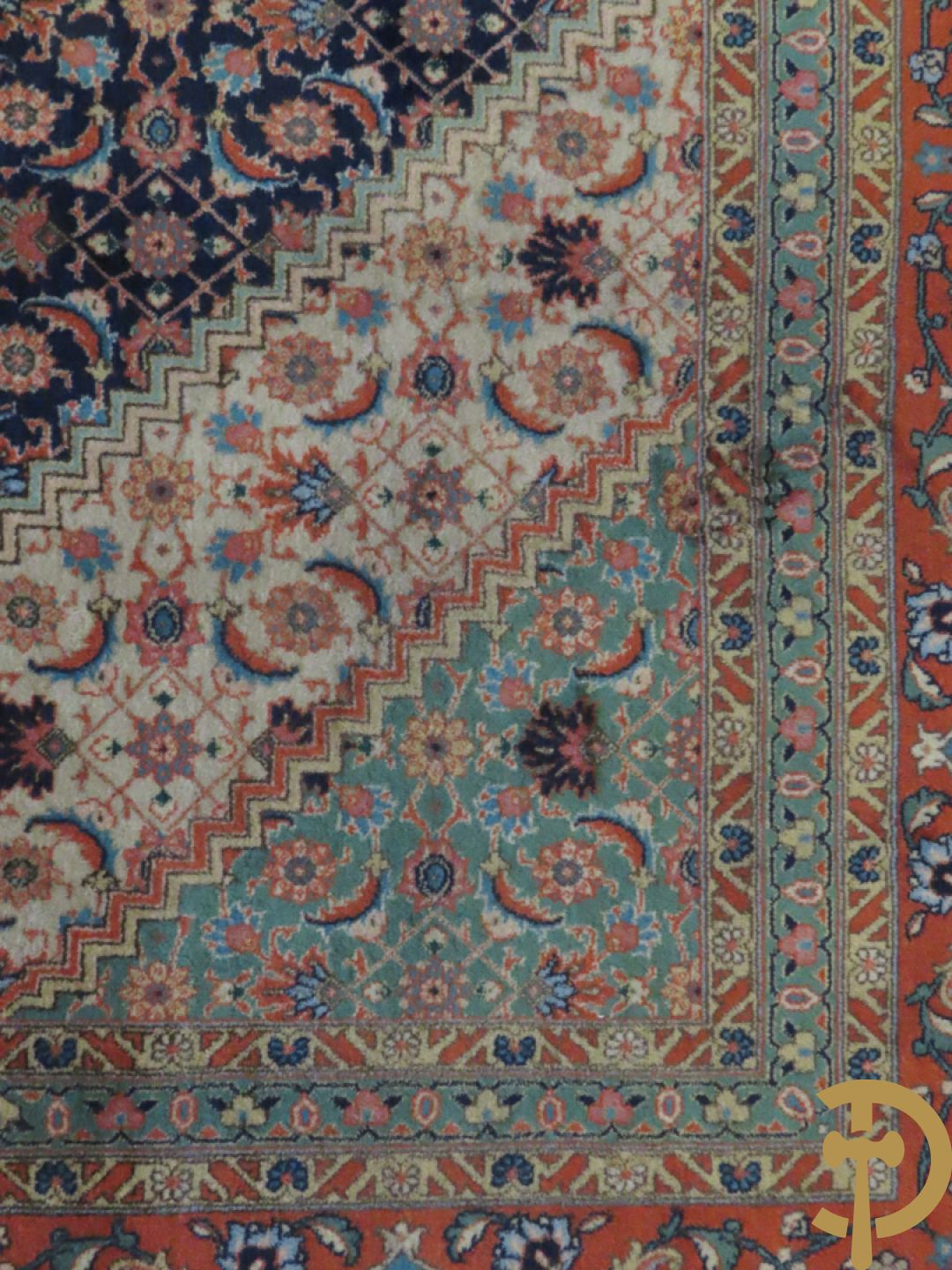 Oosters handgeknoopt tapijt met centraal decor op blauwe fond met bloemenmotieven