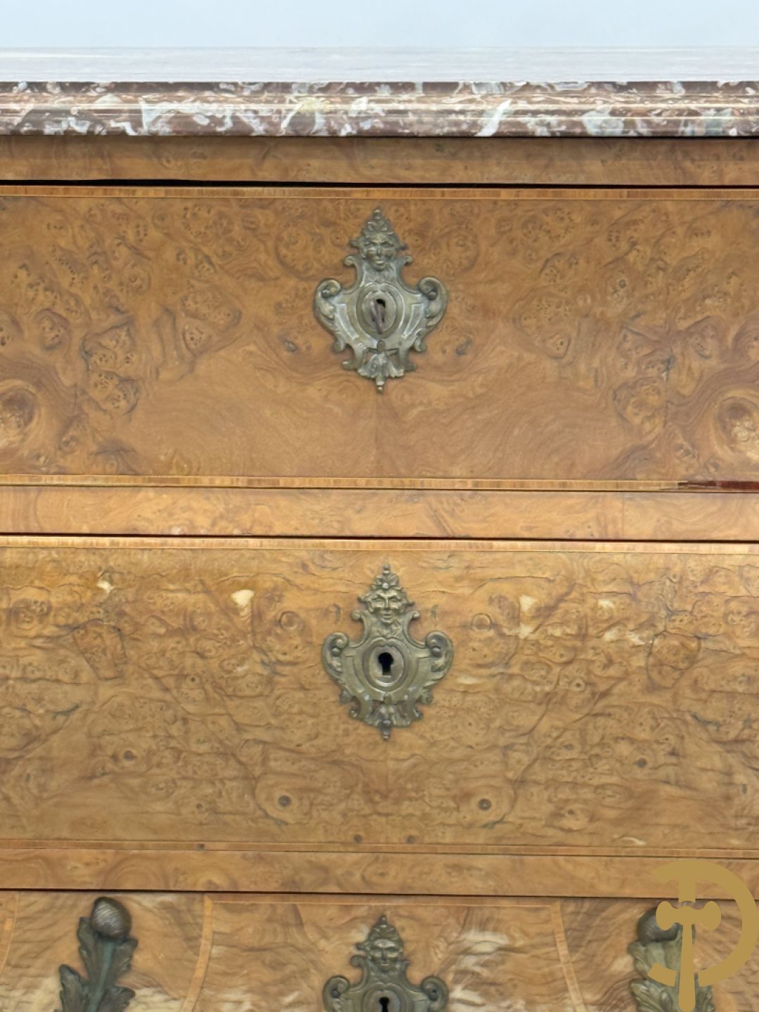 Wortelnotehouten drieladencommode met bronsbeslag van mazarinkoppen en accanthusranken, bovenaan met rood geaderd marmeren blad