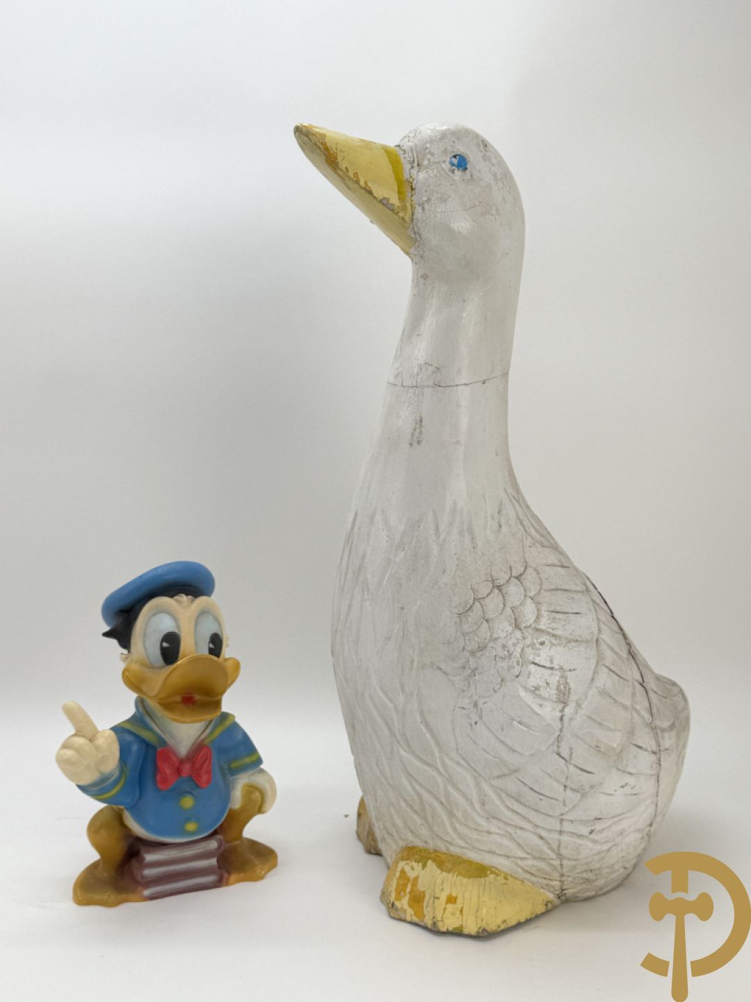 Plastic Donald Duck zittend op 3 boeken, onderaan gemerkt Disney + houten gesculpteerd beschilderde eend