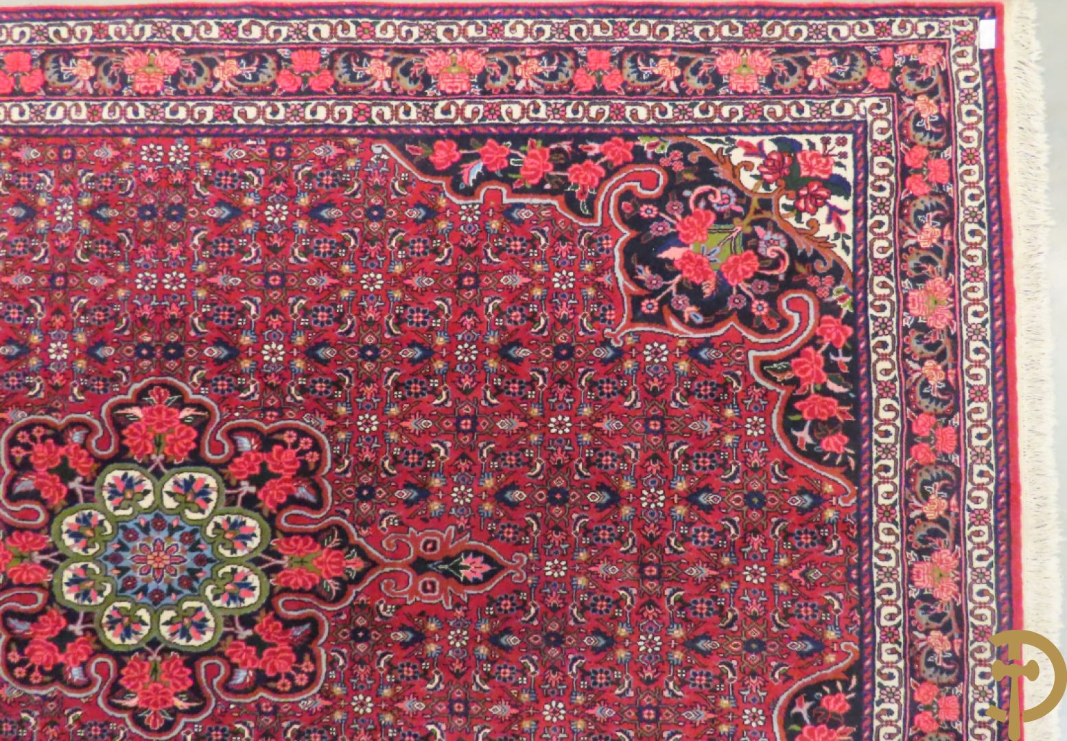 Oosters handgeknoopt tapijt met bloemenpatronen op rode fond