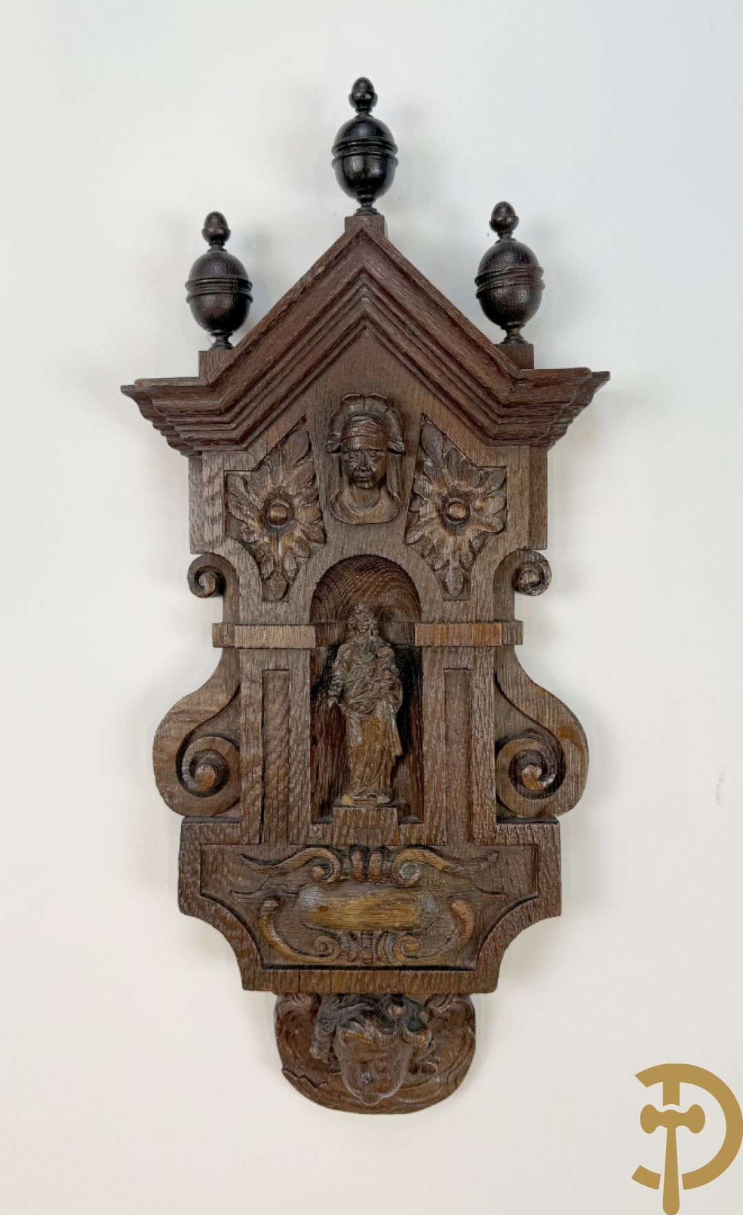 Kleine Madonna met kind in houtgesculpteerde nis, onderaan met cupidohoofd en bovenaan met fronton