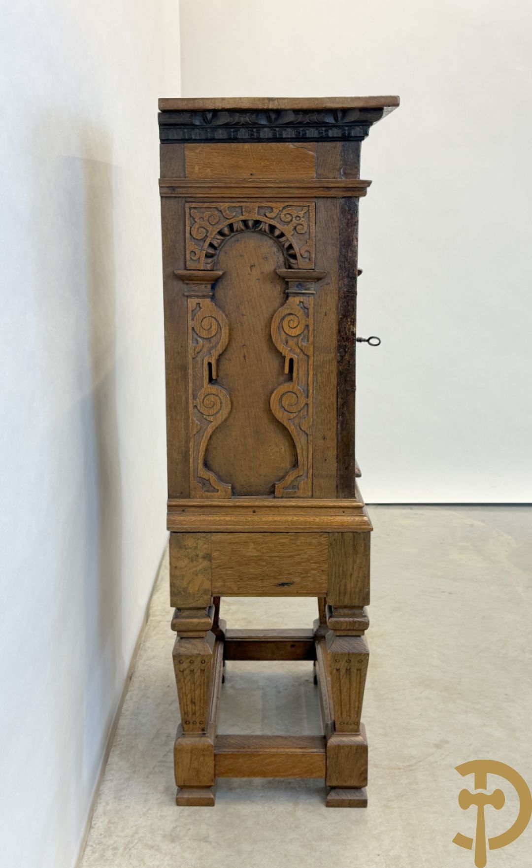 Massief eiken ééndeurskast op onderstel met lade bovenaan, lade onderaan, sculptuur in zijkant en deur