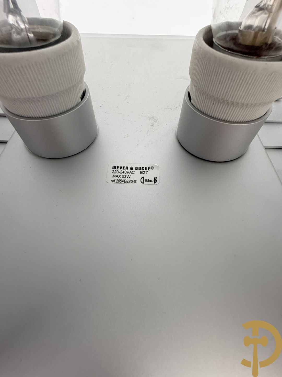 Paar verzilverde wandlampen naar model van Jules Wabbes, uitgegeven door Wever & Ducré