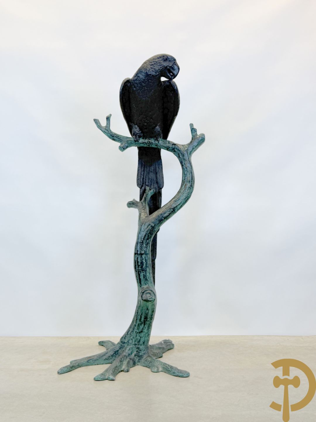 Metalen gepatineerde papegaai op boomstronk