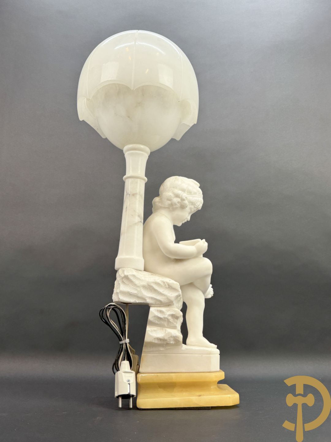 Albast beeld van jongen met boek en lamp