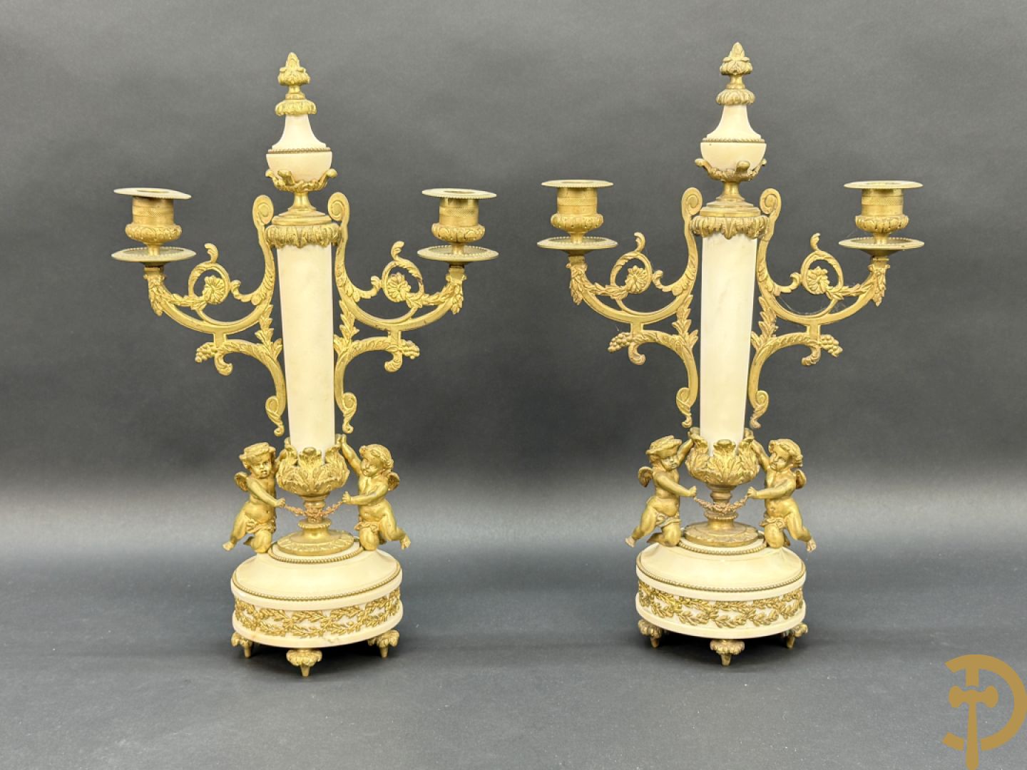 Paar marmeren kandelaars met bronzen cupido