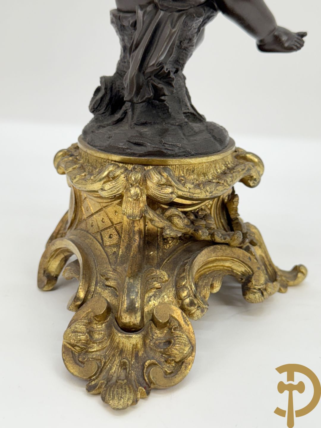 Bronzen cupido dragende een zevenarmige kandelaar