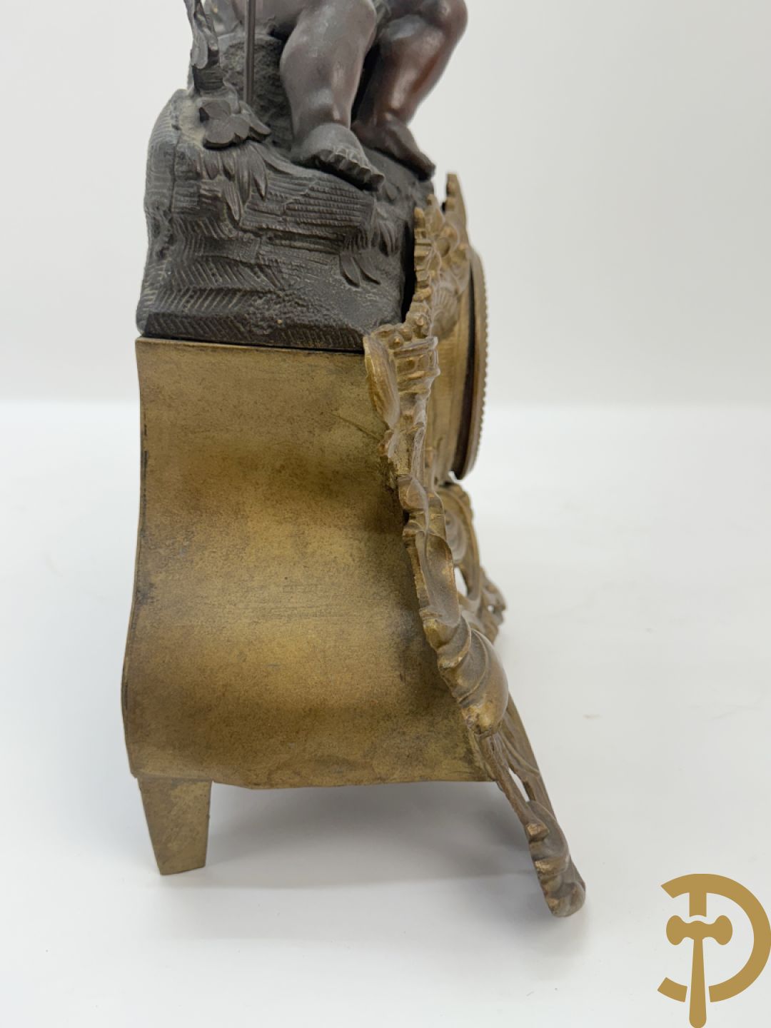 Zamak pendule met accanthusranken en bekroond met cupido met jachthoorn