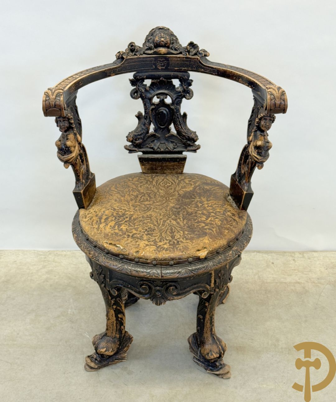 Gesculpteerde draaibare gondelvormige stoel steunend op 4 poten in de vorm van dolfijnen, bovenaan met kariathiden en engelenkoppen