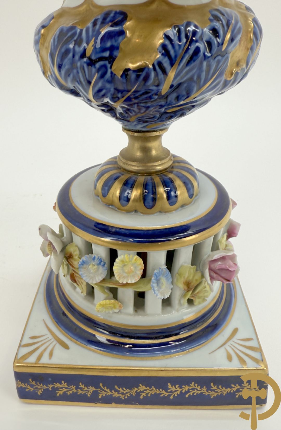 Porseleinen siervaas met handbeschilderd geanimeerd decor bezet met basrelief van bloemen en bovenaan bekroond met deksel met vogel