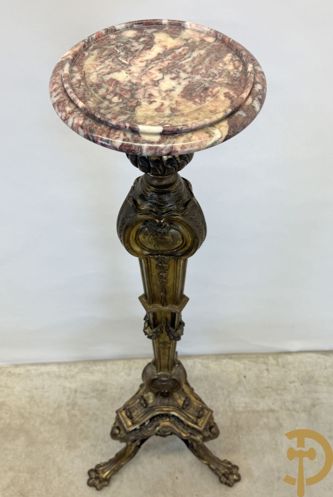 Bronzen staander op drie voluutvormige poten met acanthusranken, bezet met guirlandes en bovenaan met marmeren plateau