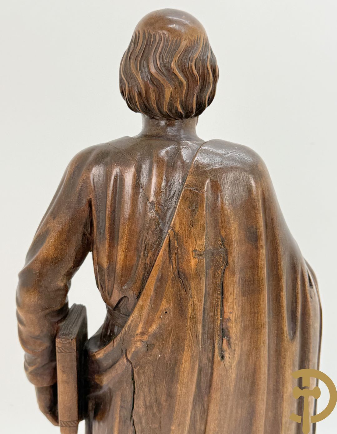 Houtsculptuur van evangelist met boek in de hand