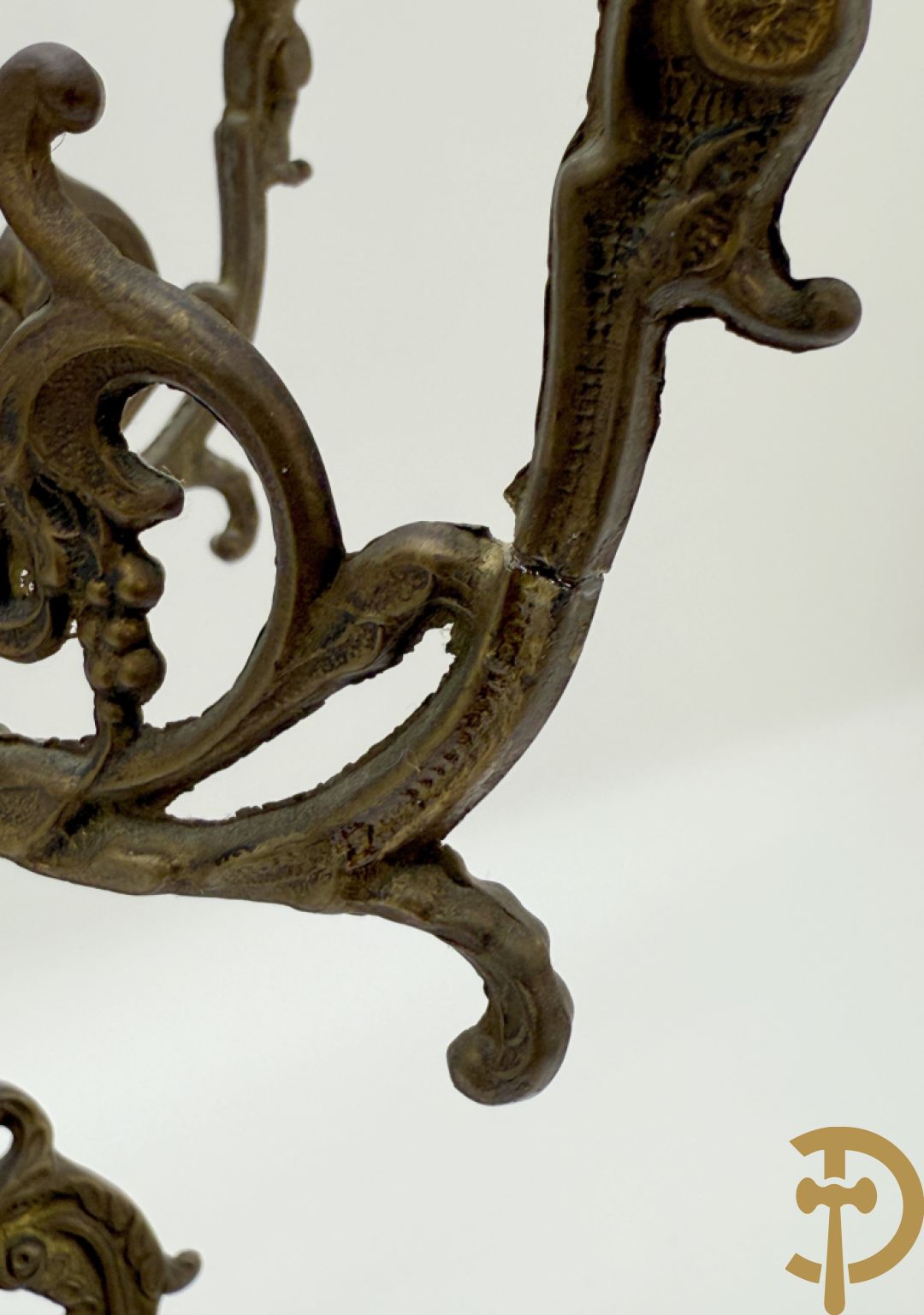 Driedelige koperen garnituur, klok geflankeerd door paar vijfarmige kandelaars