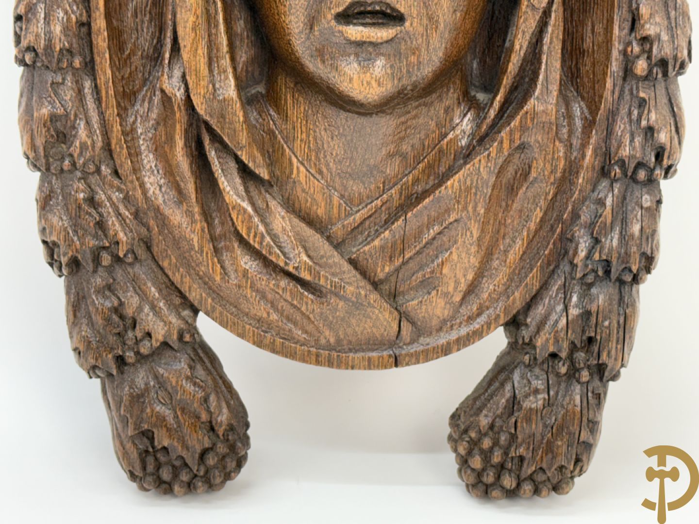 Houtgesculpteerd basrelief van wenende dame in cartouche met accanthusranken