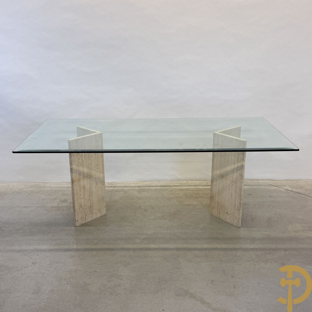 Moderne tafel met geslepen glazen blad op 2 travertin steunen