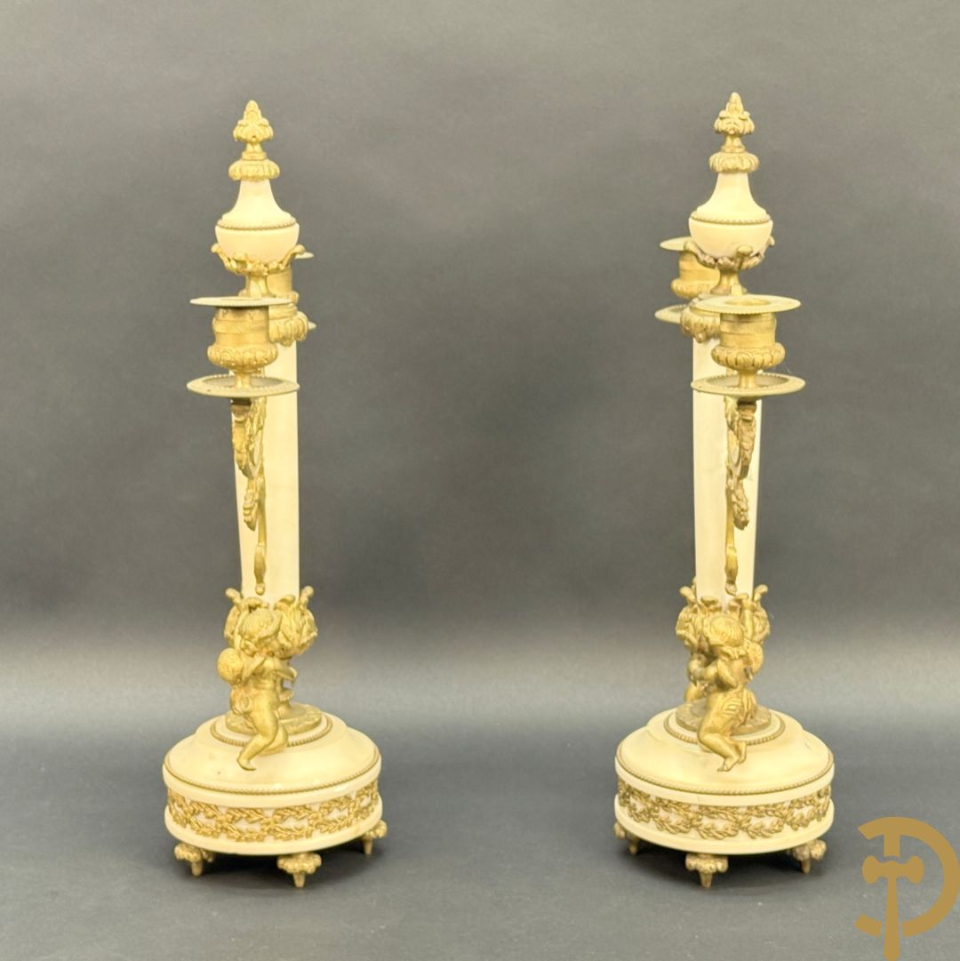 Paar marmeren kandelaars met bronzen cupido