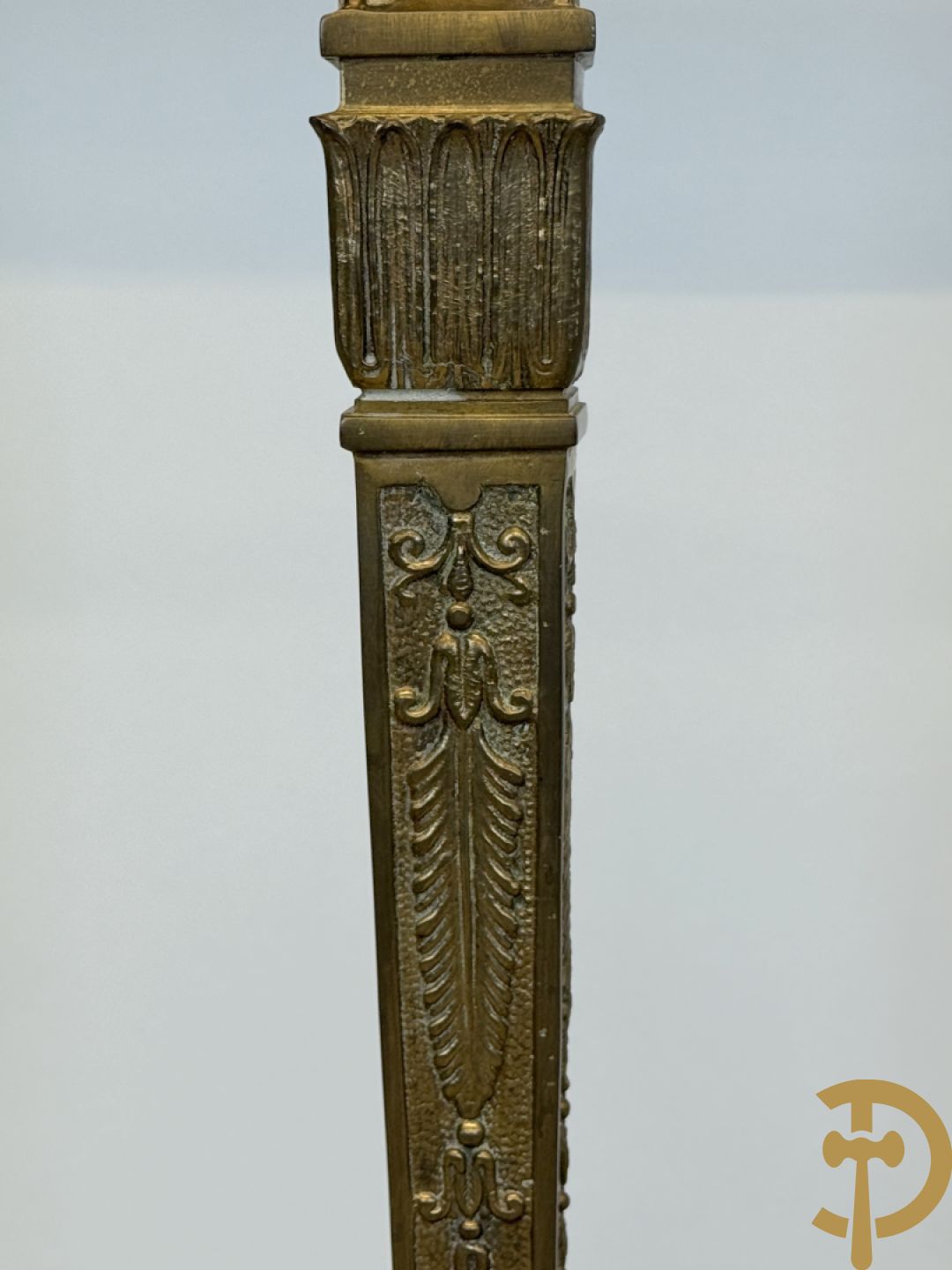 Console op bronzen poten met dameshoofden bezet, bovenaan met groen marmeren blad