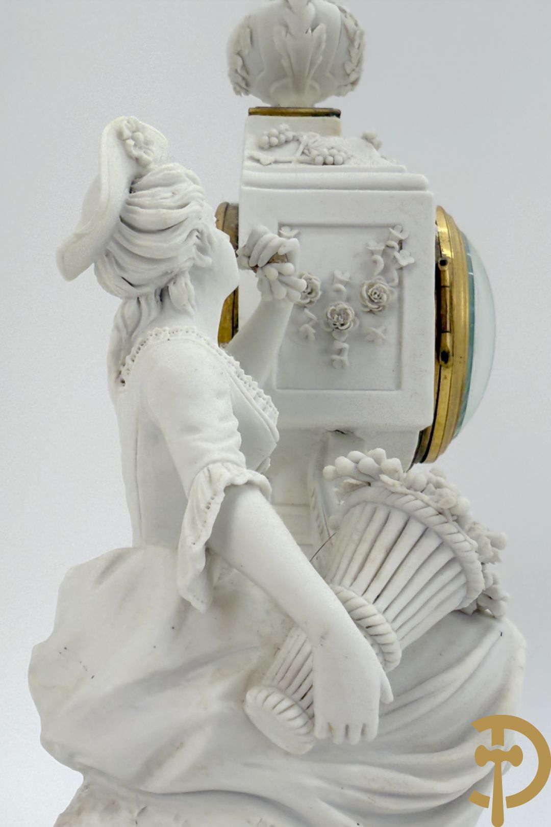 Driedelige porseleinen garnituur met bronsbeslag bestaande uit pendule met dame en amfoor geflankeerd door paar kandelaars bezet met personages