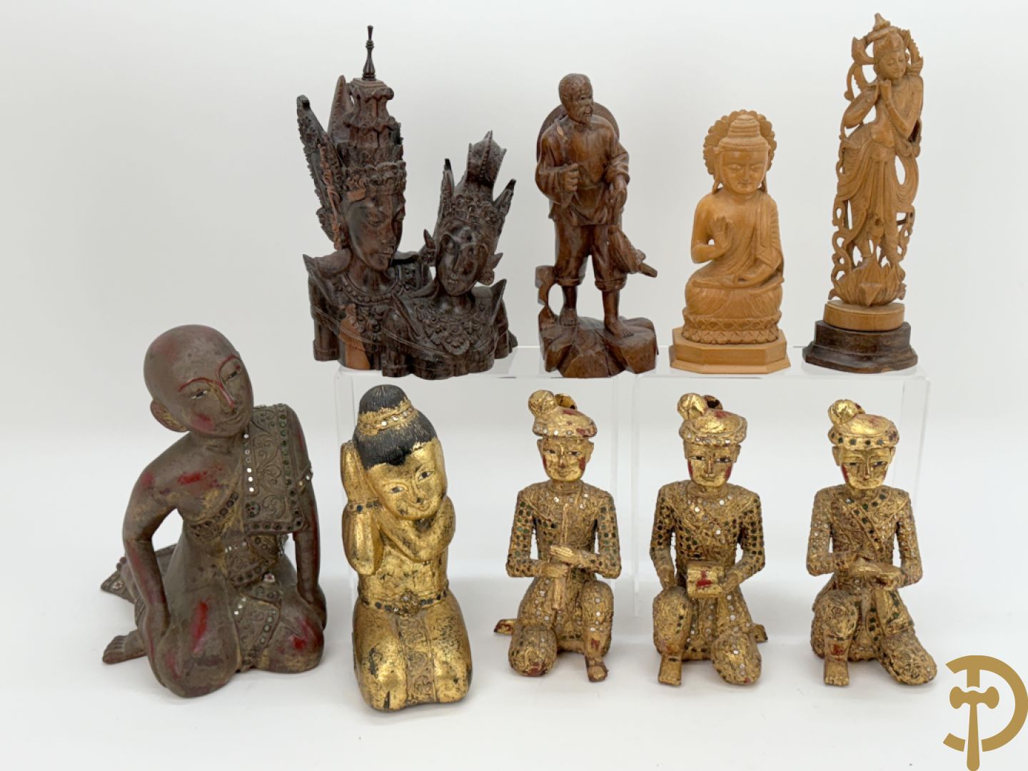 Negen houtgesculpteerde boedhistische figuren waarvan enkele verguld
