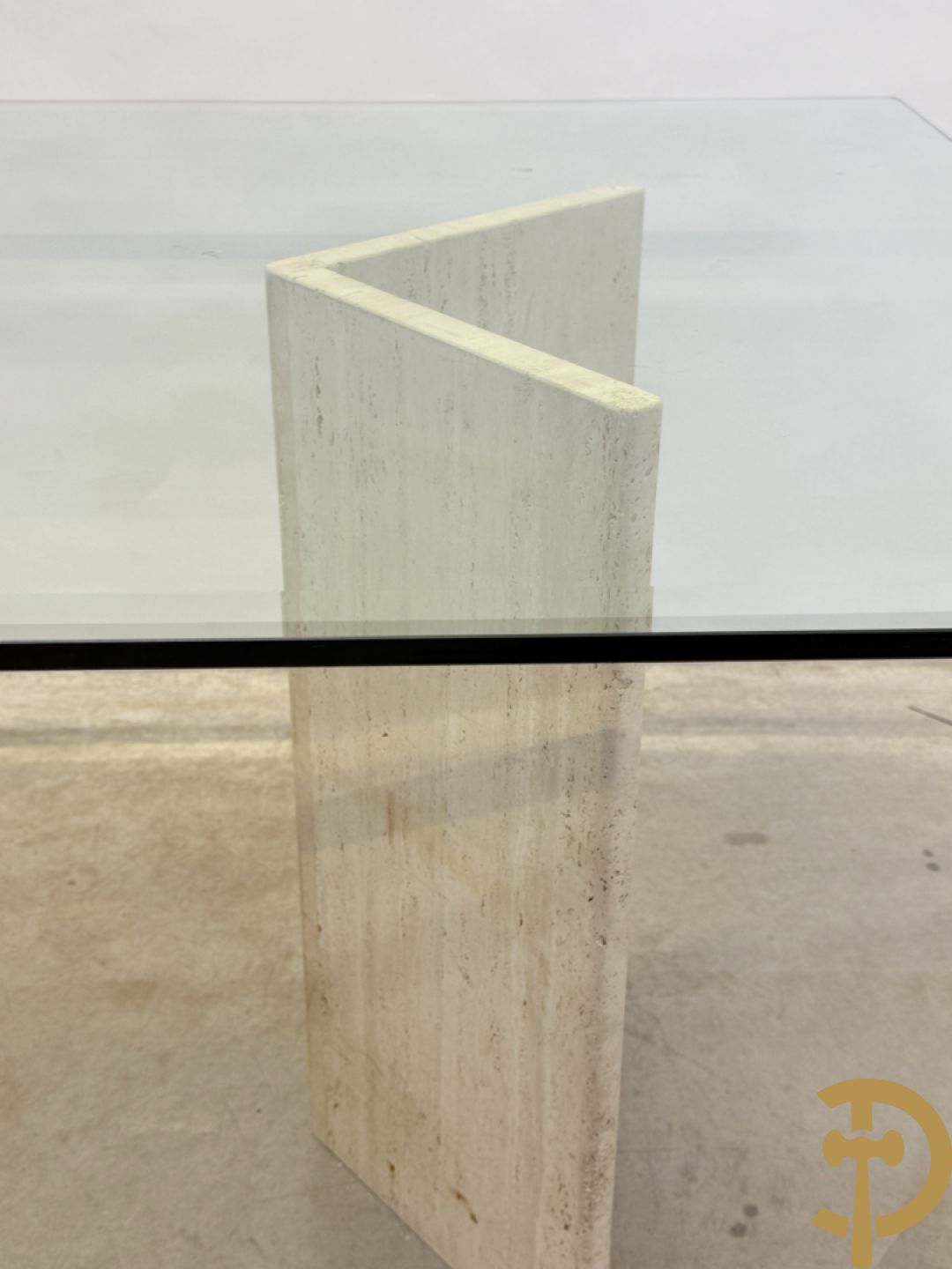 Moderne tafel met geslepen glazen blad op 2 travertin steunen