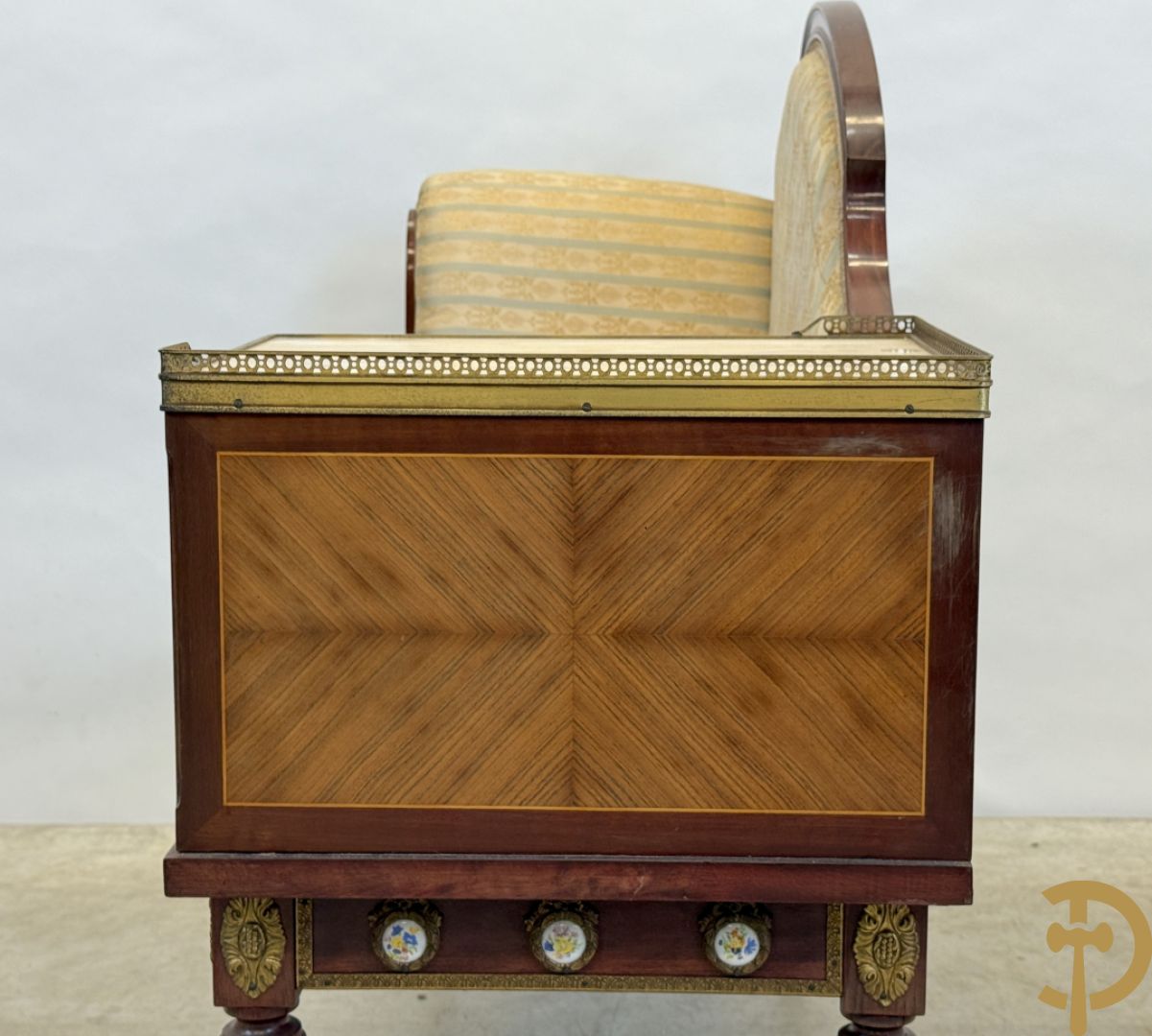 Banquette met ingebouwd bijzettafeltje bezet met porseleinen plakkettes op gecanneleerde poten