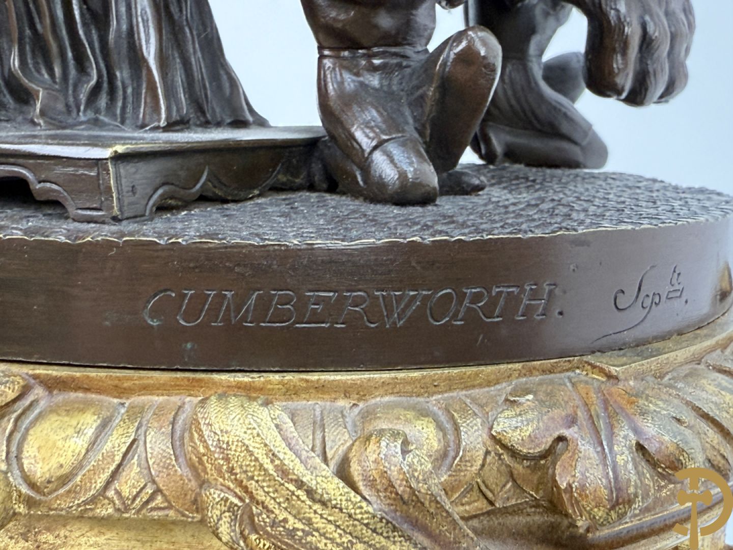 Driedelige bronzen garnituur bestaande uit middenstuk met bronzen vuurvergulde klok, Daubrée gemerkt à Nancy, bovenaan bekroond met Cleopatra met drinkbeker - getekend van Cumberworth sculpteur - geflankeerd door paar cupido