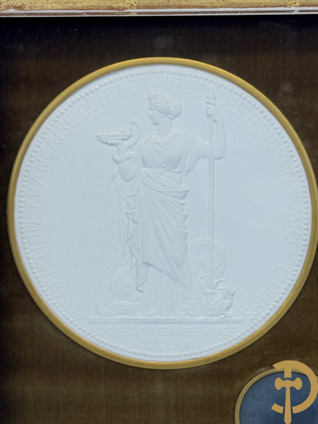 Kader met twee porseleinen plakkettes en 3 munten van Oudiné Eugène André