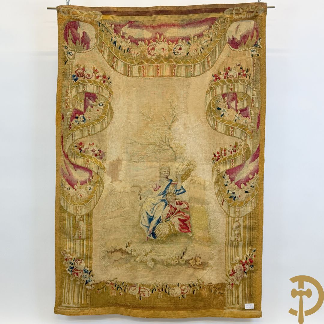 Handgeweven wandtapijt met centraal decor van dames in landschap met de oogst omgeven door bloemenguirlandes