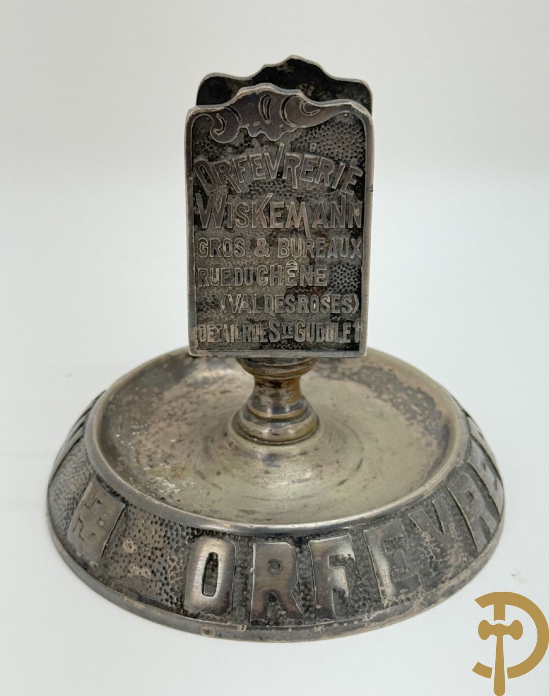 Vier luciferhouders in verzilverd metalen met reclame opschriften van Wiskeman (2 x) , Orfeverie Van Den Torren en Orfeverie L. Haut