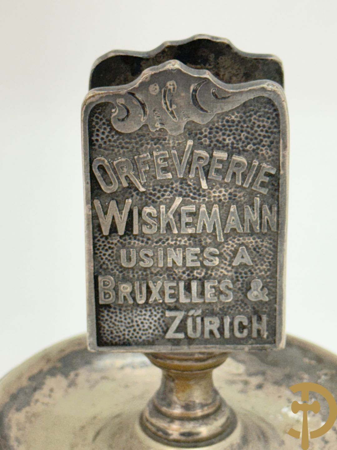 Vier luciferhouders in verzilverd metalen met reclame opschriften van Wiskeman (2 x) , Orfeverie Van Den Torren en Orfeverie L. Haut