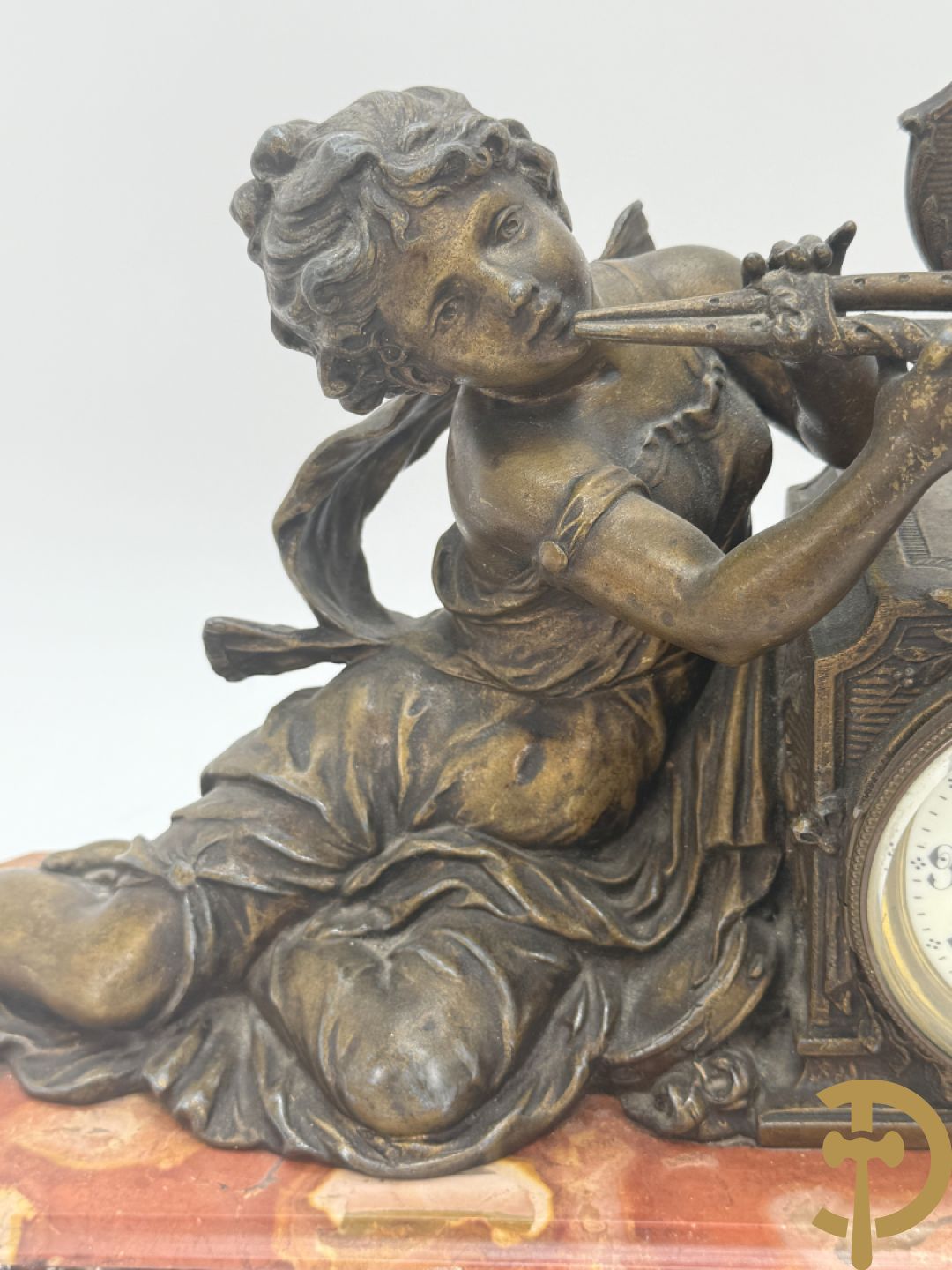 Driedelige garnituur, centraal horloge gedecoreerd met zamak beeld van fluitspelende cupido, geflankeerd door paar cassolettes - alles op marmeren basis