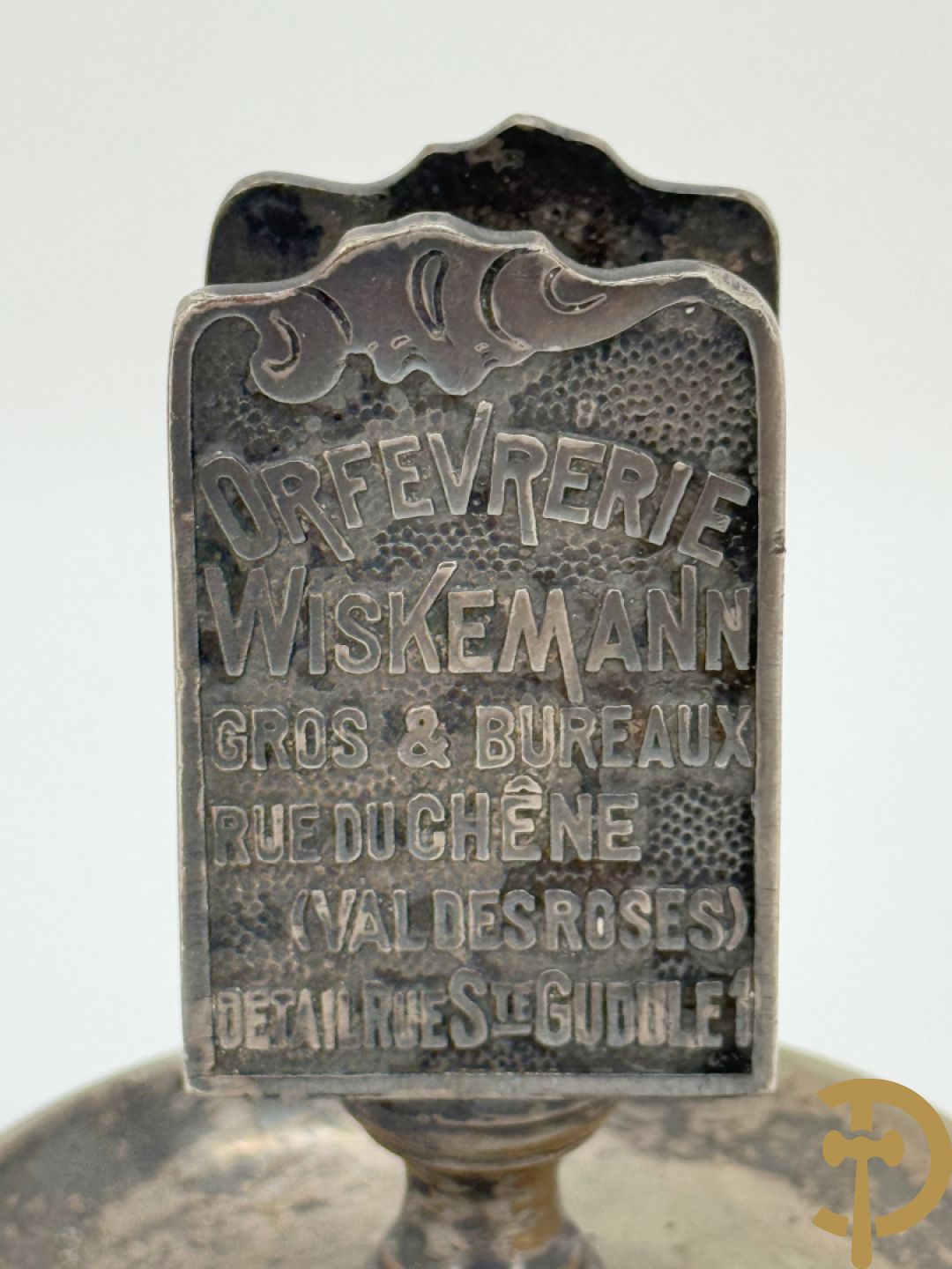 Vier luciferhouders in verzilverd metalen met reclame opschriften van Wiskeman (2 x) , Orfeverie Van Den Torren en Orfeverie L. Haut