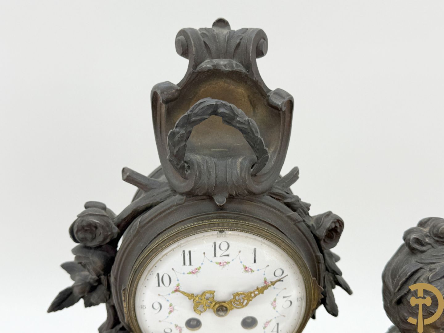 Driedelige kunstbronzen garnituur bestaande uit klok met liggende dame met amfoor op marmeren basis, geflankeerd door paar cassolettes met cupido
