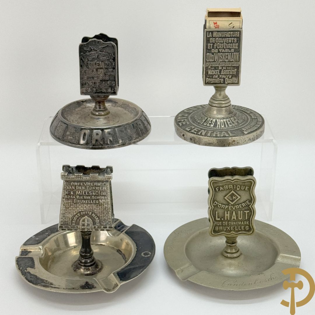 Vier luciferhouders in verzilverd metalen met reclame opschriften van Wiskeman (2 x) , Orfeverie Van Den Torren en Orfeverie L. Haut
