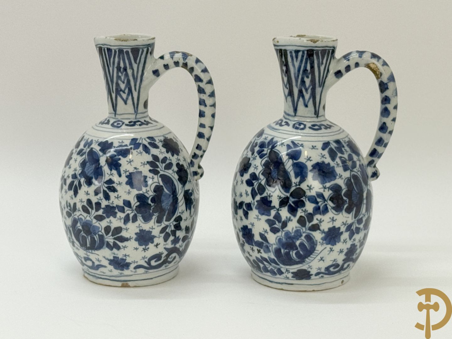 Twee Delftse blauw/wit schenkkannen met bloemendecor