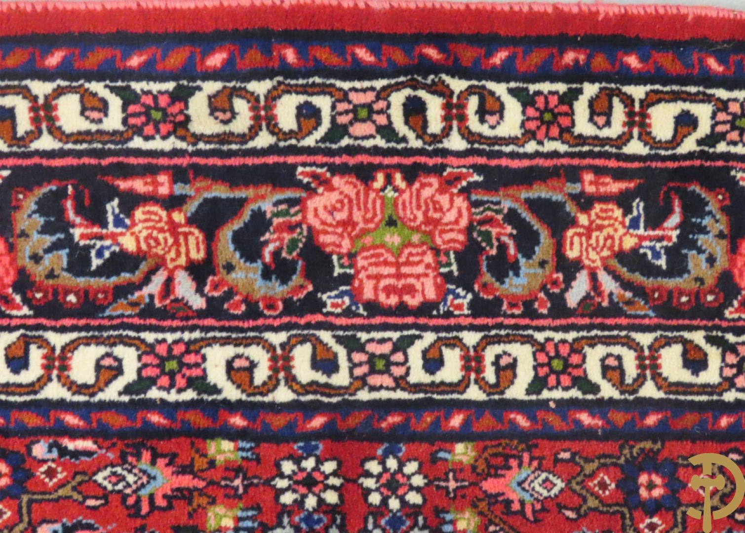 Oosters handgeknoopt tapijt met bloemenpatronen op rode fond