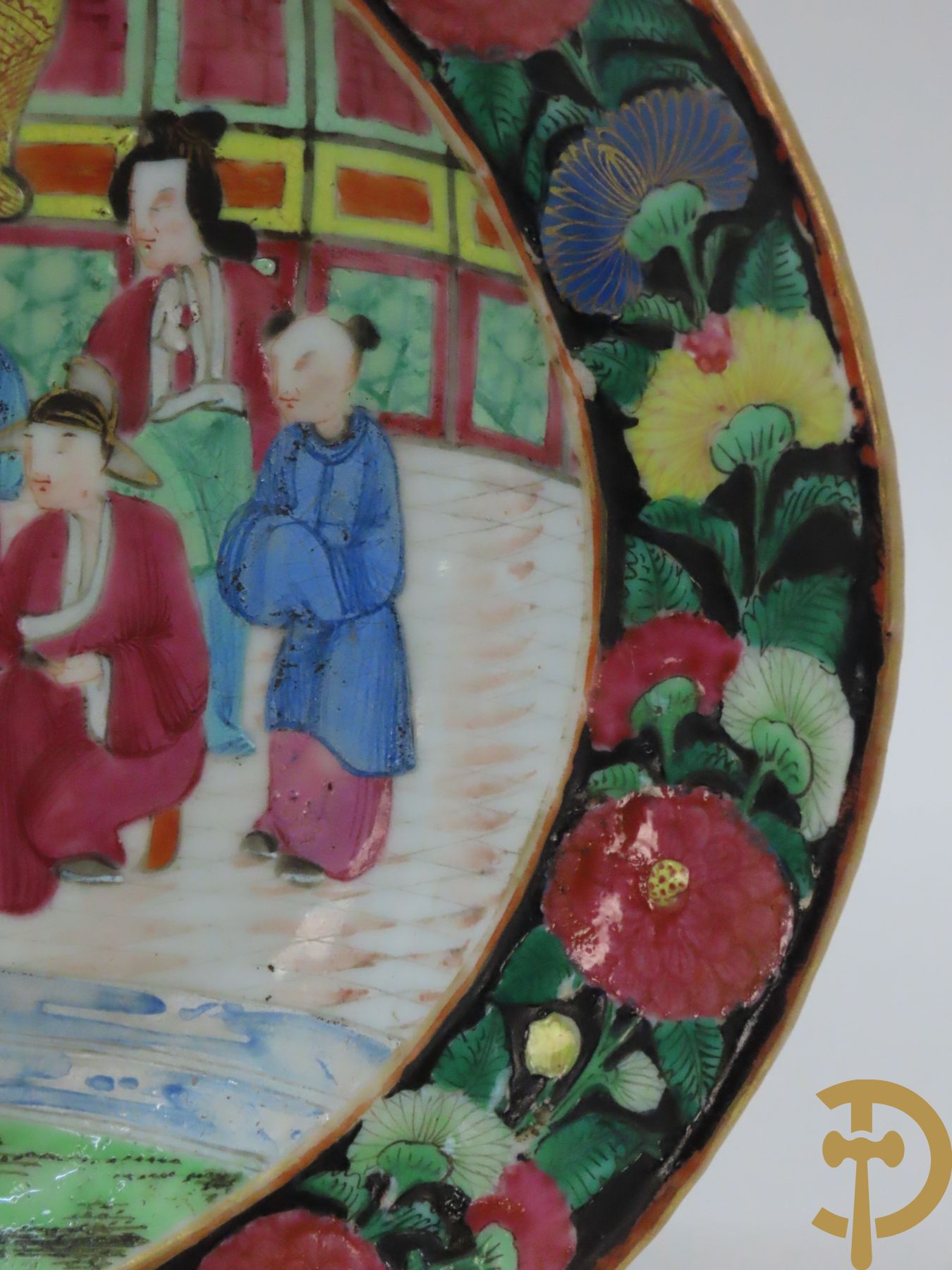 Ovaal Chinees porseleinen Kantonbord met geanimeerde interieurscène, omrand door bloemen