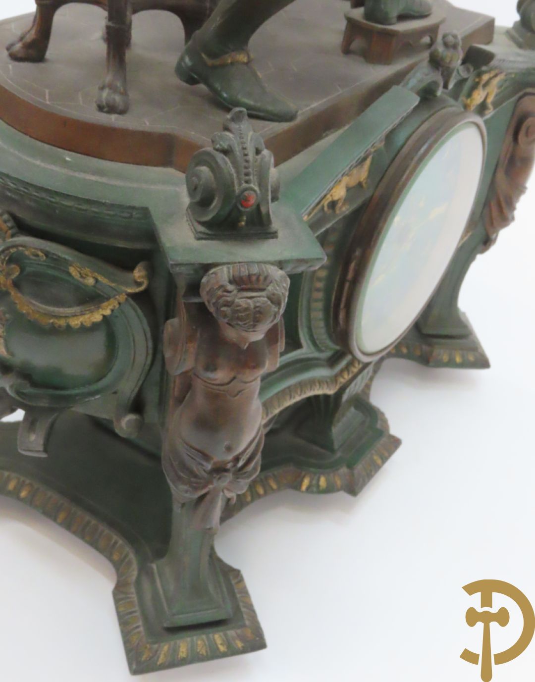 Driedelige kunstbronzen garnituur bestaande uit pendule met paar schakende edelheren, bezet met kariatiden - geflankeerd door paar driearmige kandelaars gehouden door 2 edelheren