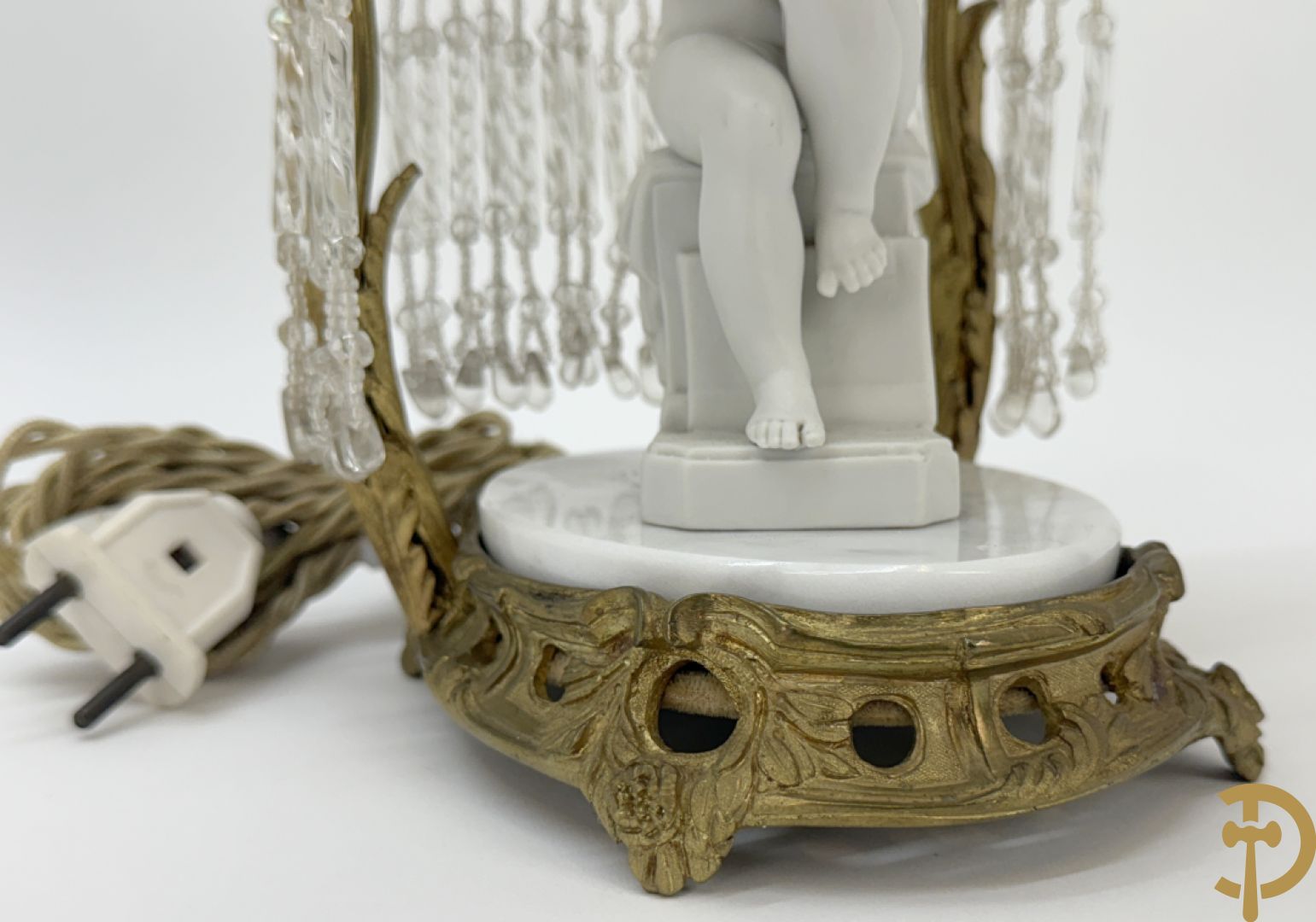 Biscuitbeeld van schrijvende cupido onder bronzen dakje met kristallen bellen bezet - op marmeren sokkel gemonteerd