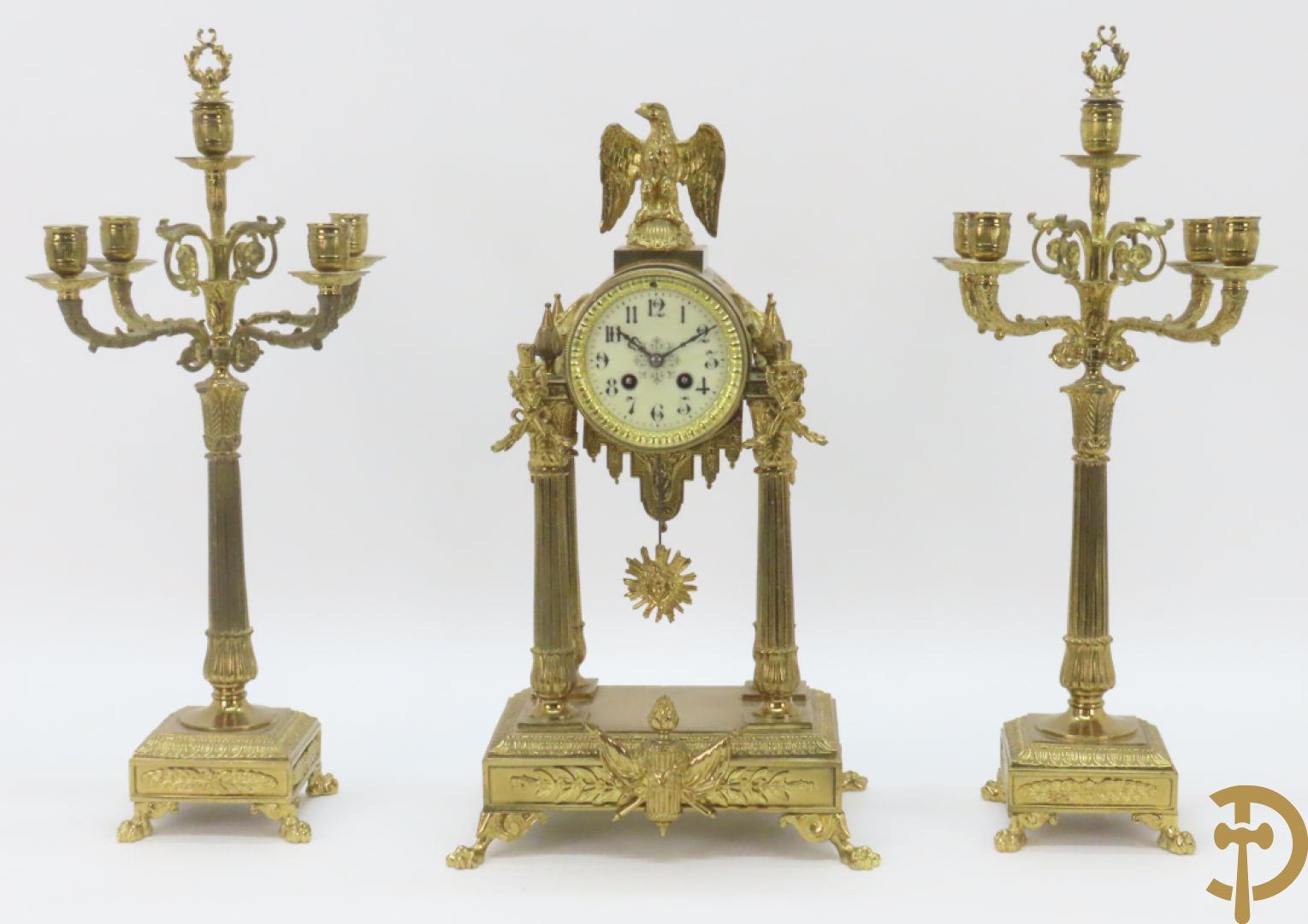 Driedelige bronzen garnituur bestaande uit middenstuk met 4 gecanneleerde zuilen en adelaar bezet + paar kandelaars