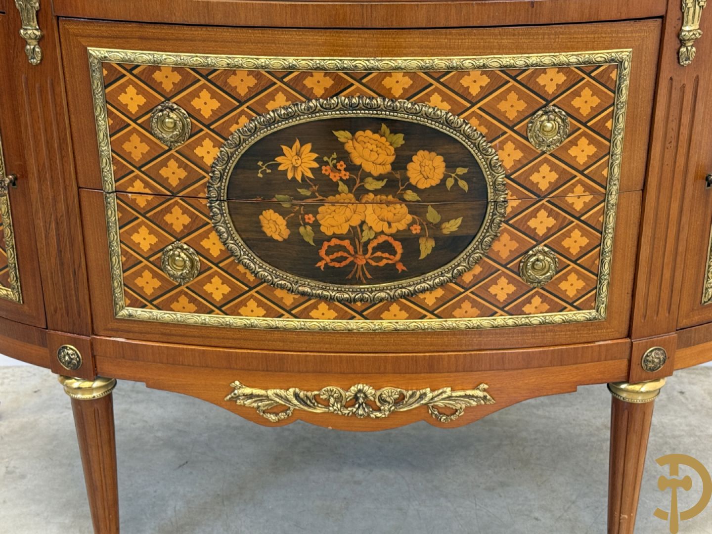 Halve maanvormige drieladencommode met 2 zijdelingse deuren, gemarketteerde bloemenmotieven en bronzen ornamenten, bovenaan bezet met marmeren blad