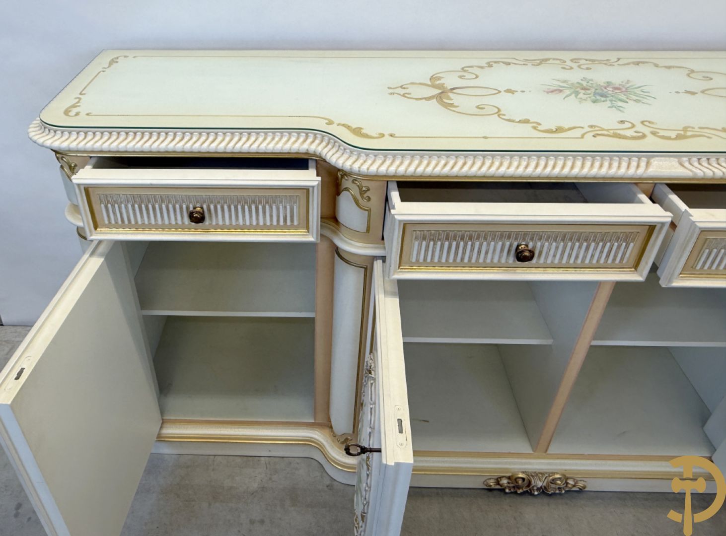 Italiaanse eetkamer met beschilderd bloemenmotief bestaande uit vierdeursdressoir met beschilderde bloemenmotieven, accanthusranken en glazen blad, tafel op gesculpteerde poten en 6 stoelen