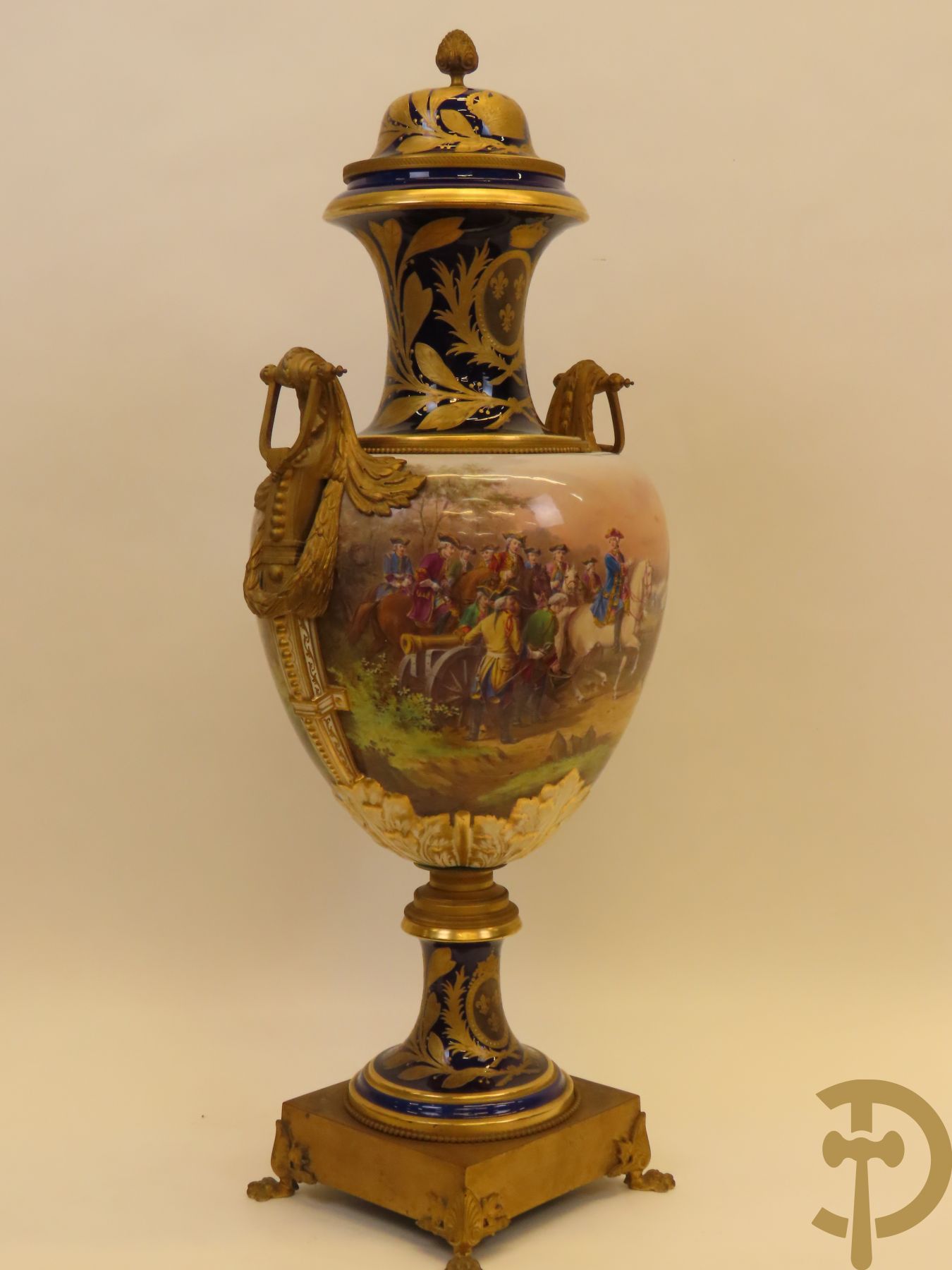 Grote porseleinen Sèvres vaas met dubbel decor van cavalerie, slagveldtaferelen en zicht op kasteel, DESPREZ H. getekend in het decor - bovenaan met verguld decor en zijdelings met bronzen oren en accanthusranken - deksel met Sèvres merkteken - op vierkante bronzen sokkel met klauwepoten