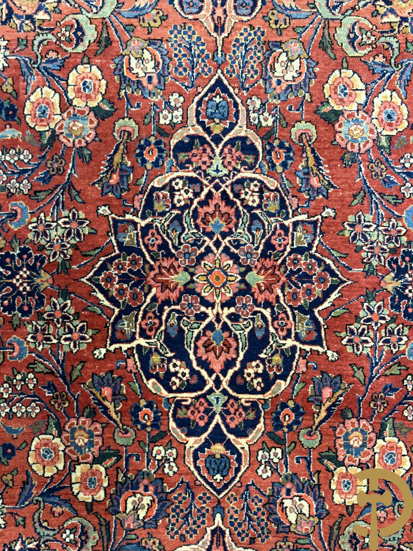 Oosters handgeknoopt tapijt met bloemenmotieven op rode fond