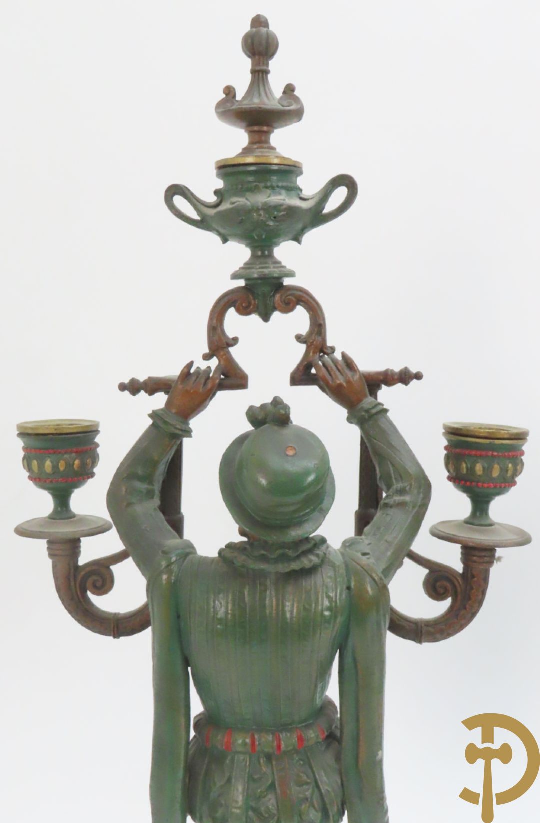 Driedelige kunstbronzen garnituur bestaande uit pendule met paar schakende edelheren, bezet met kariatiden - geflankeerd door paar driearmige kandelaars gehouden door 2 edelheren