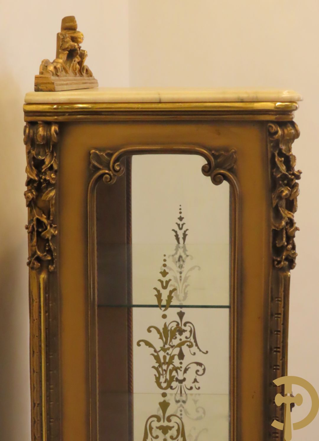 Vergulde vitrine met accanthusranken en ornamentiek in de ruiten geslepen, bovenaan bezet met marmeren blad