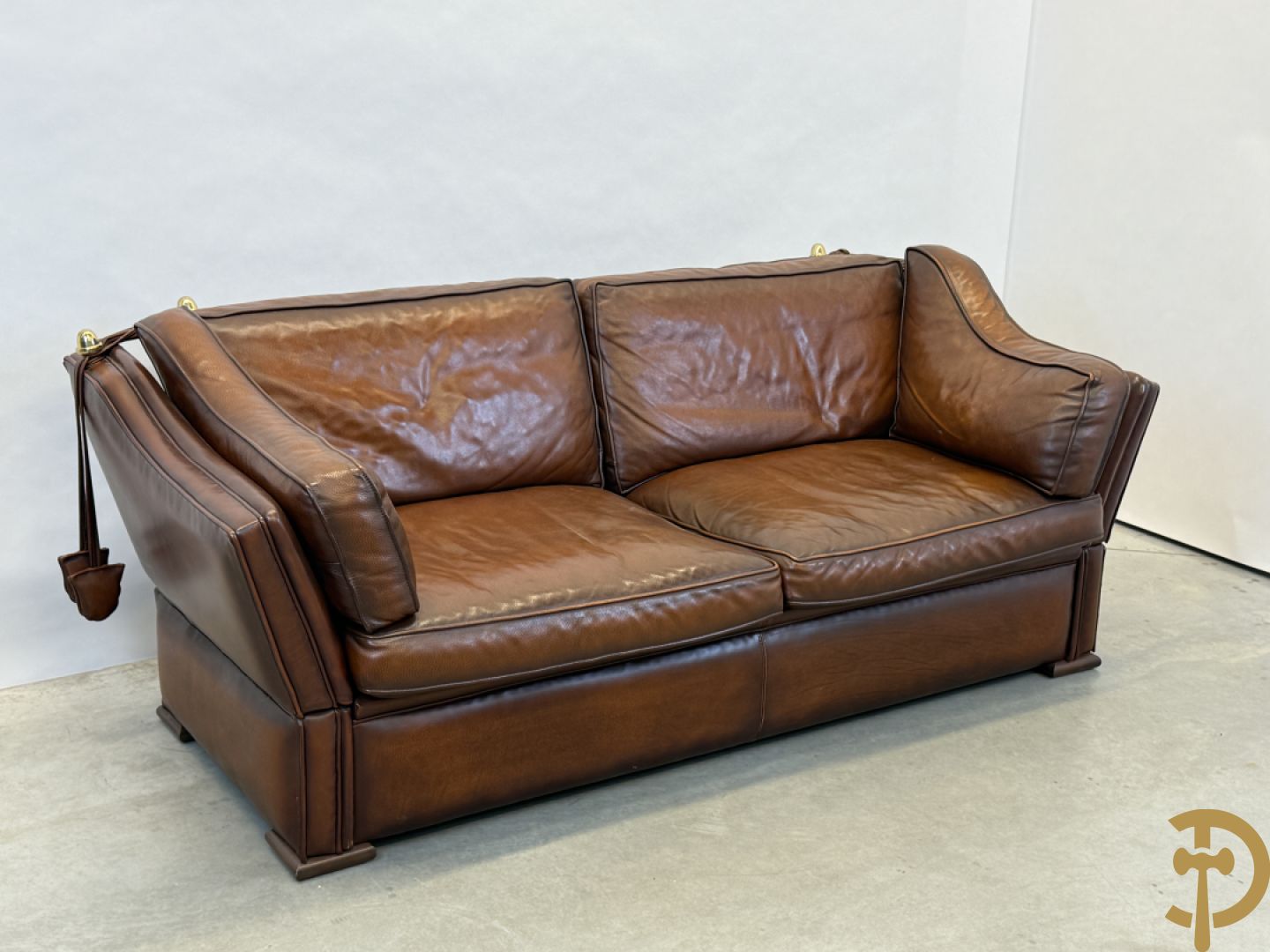 Bruin lederen canapé met kantelbare zijkanten en koperen denappels