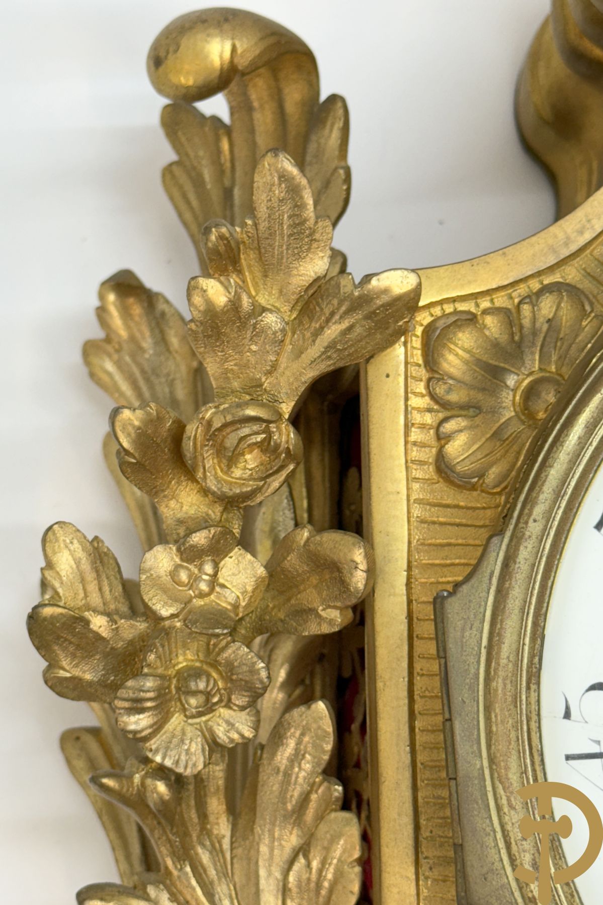 Bronzen muurkartel Louis XV stijl met bloemenmotieven en bovenaan bezet met faune met triangle, Molle Paris getekend binnenin op uurwerk