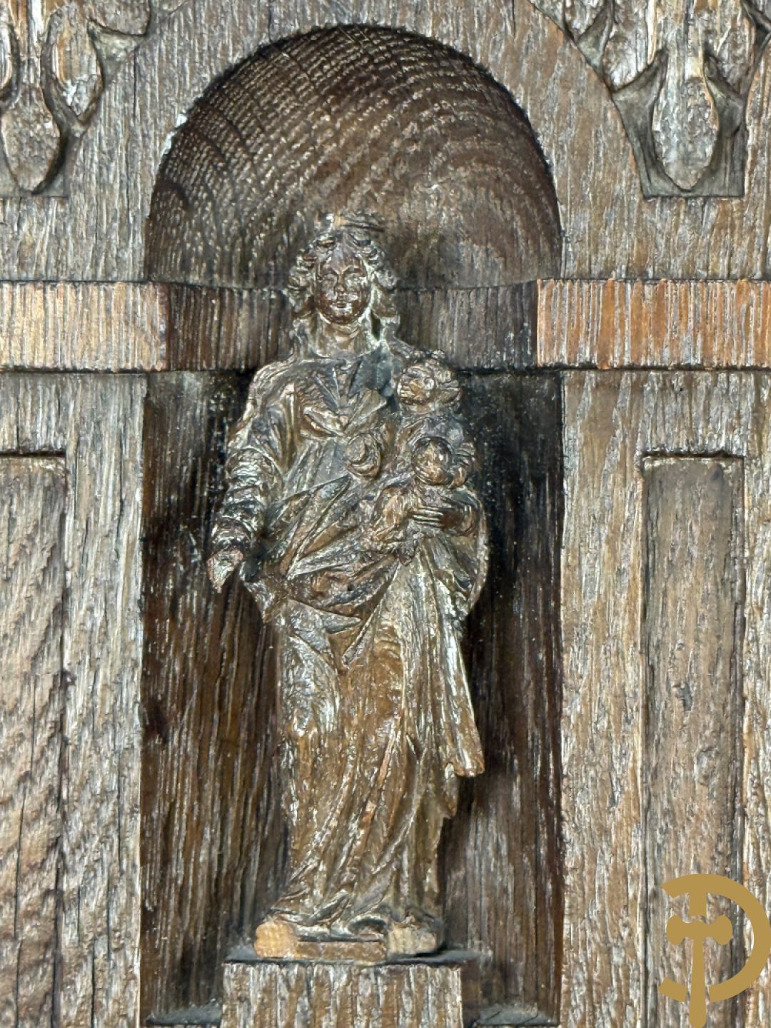 Kleine Madonna met kind in houtgesculpteerde nis, onderaan met cupidohoofd en bovenaan met fronton